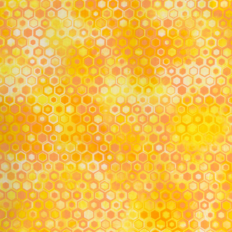beautifully mottled geometric fabric featuring a honeycomb pattern filled with nestled hexagons in varied shades of vibrant yellow, orange, and peach