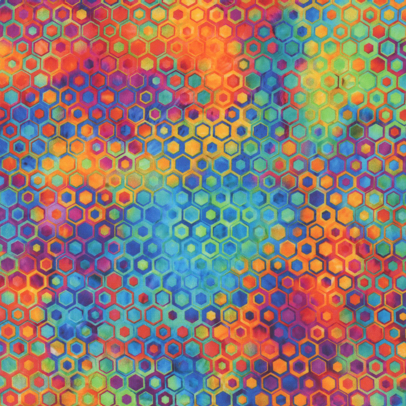 beautifully mottled geometric fabric featuring a honeycomb pattern filled with nestled hexagons in varied shades of vibrant red, blue, green, yellow, orange, and purple