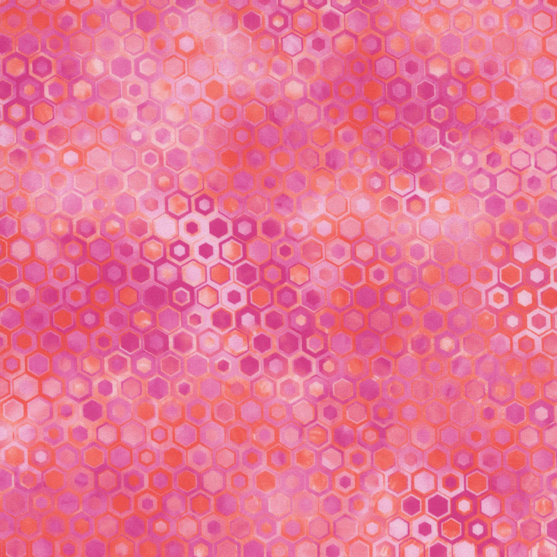 beautifully mottled geometric fabric featuring a honeycomb pattern filled with nestled hexagons in varied shades of vibrant pink, fuchsia, and red