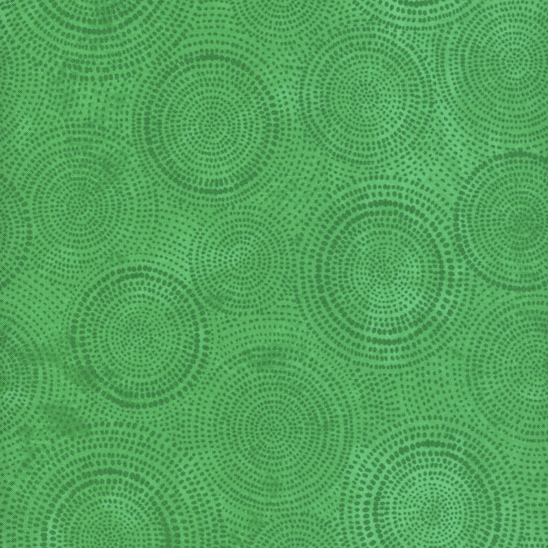 Photo of bright green mottled fabric with dark tonal rings made up of tiny dashes
