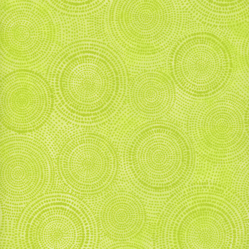 Photo of bright lime green mottled fabric with dark tonal rings made up of tiny dashes