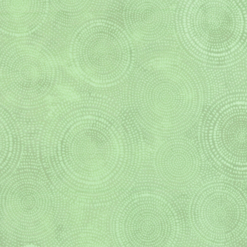 Photo of light aqua mottled fabric with pale tonal rings made up of tiny dashes