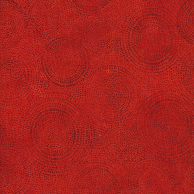 Photo of deep red mottled fabric with dark tonal rings made up of tiny dashes