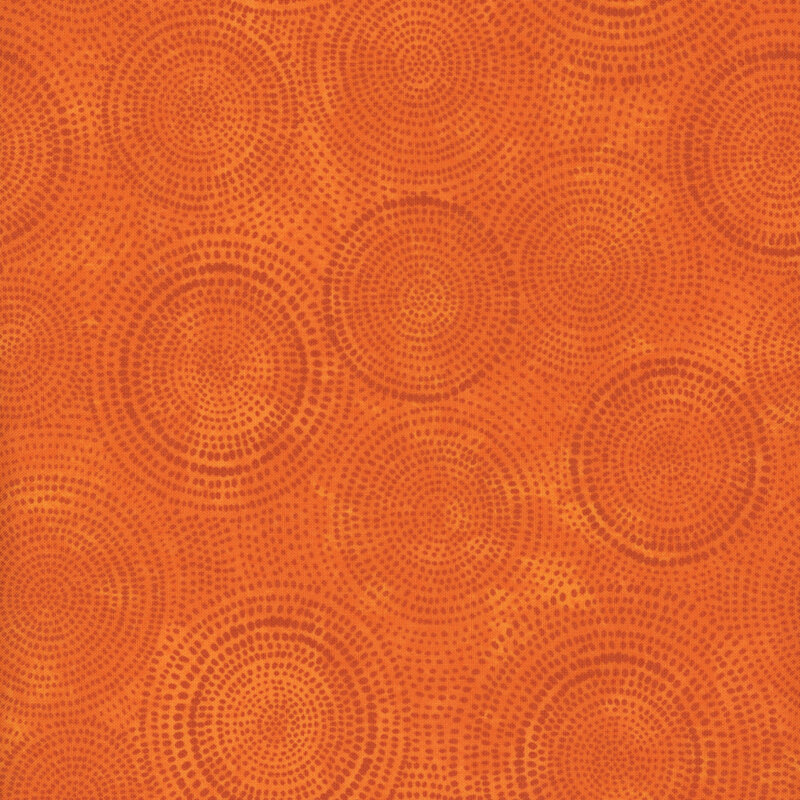 Photo of bright orange mottled fabric with dark tonal rings made up of tiny dashes