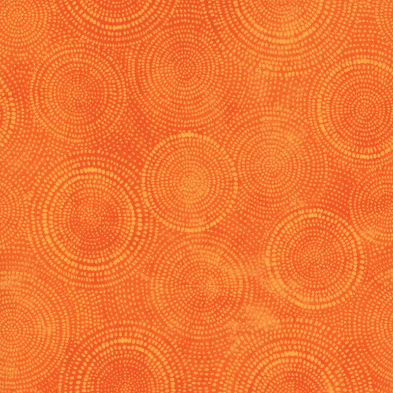 Photo of bright orange mottled fabric with pale tonal rings made up of tiny dashes