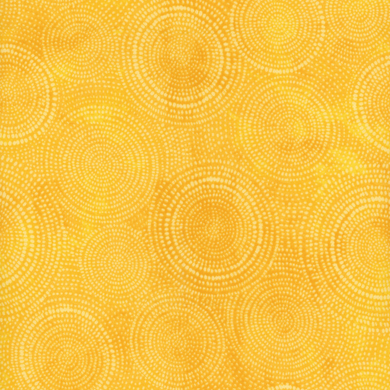 Photo of bright yellow mottled fabric with pale tonal rings made up of tiny dashes