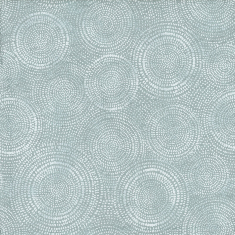 Photo of silver mottled fabric with an aqua cast and pale tonal rings made up of tiny dashes