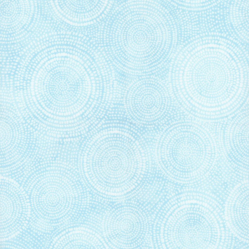 Photo of light blue mottled fabric with pale tonal rings made up of tiny dashes