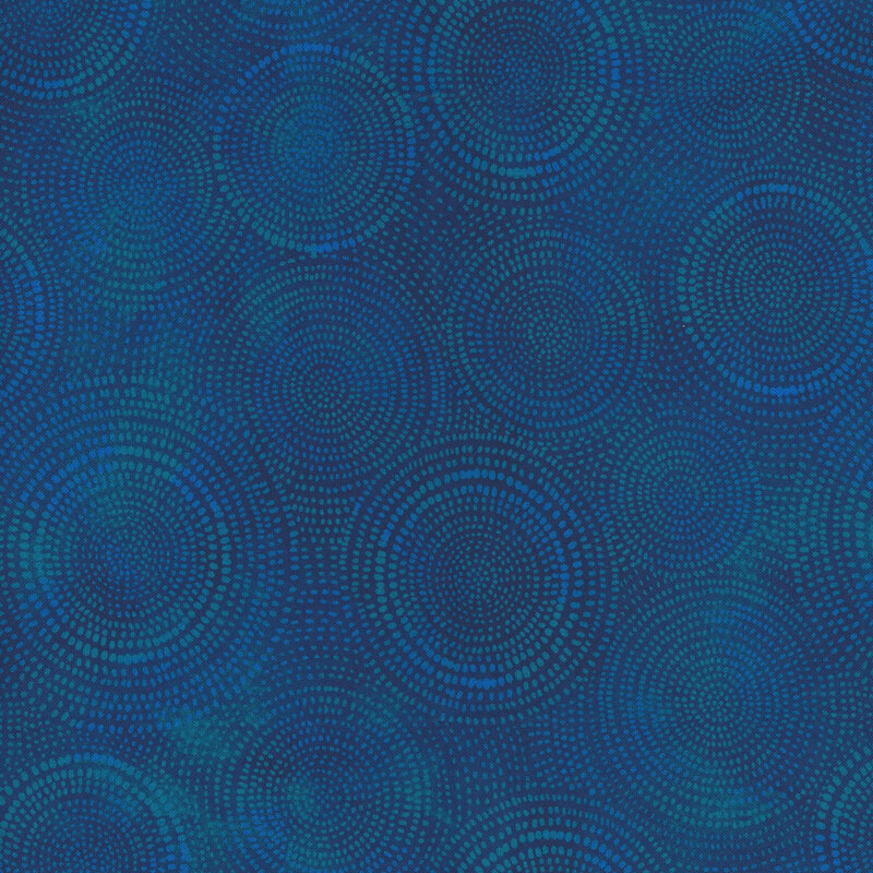 Photo of dark blue mottled fabric with lighter tonal rings made up of tiny dashes