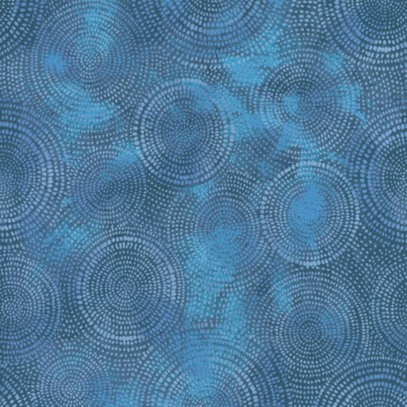 Photo of blue mottled fabric with lighter tonal rings made up of tiny dashes