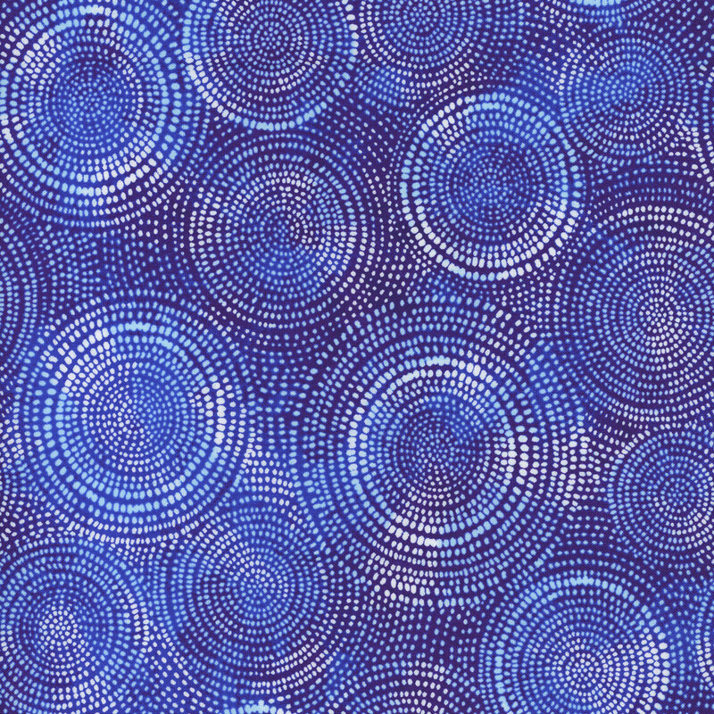 Photo of royal blue mottled fabric with white mottled rings made up of tiny dashes