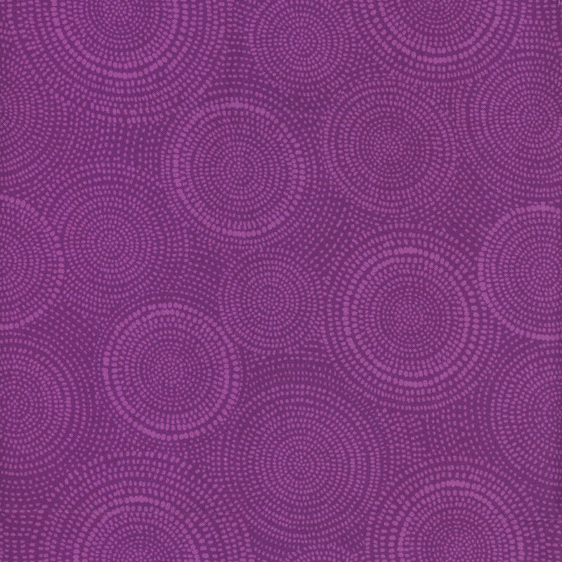 Photo of purple mottled fabric with lighter tonal rings made up of tiny dashes