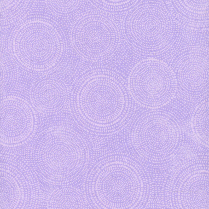 Photo of light purple mottled fabric with lighter tonal rings made up of tiny dashes