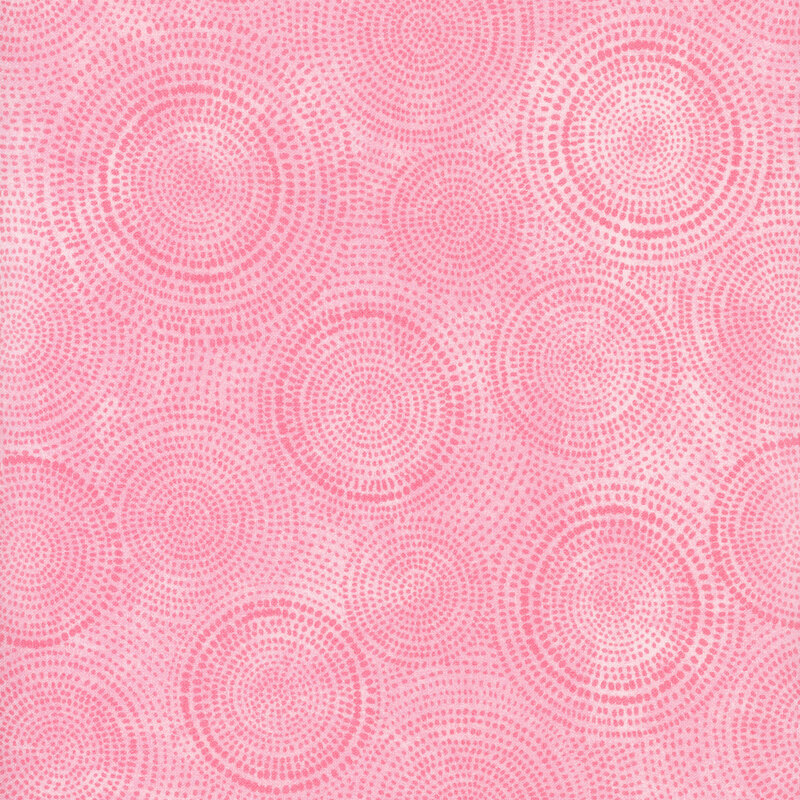 Photo of light pink mottled fabric with darker tonal rings made up of tiny dashes