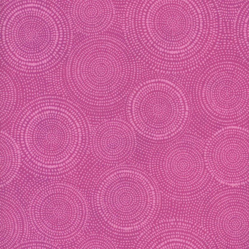 Photo of pink mottled fabric with lighter tonal rings made up of tiny dashes