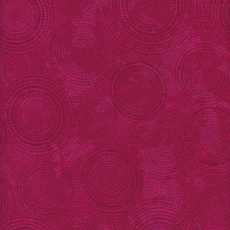 Photo of magenta pink mottled fabric with darker tonal rings made up of tiny dashes