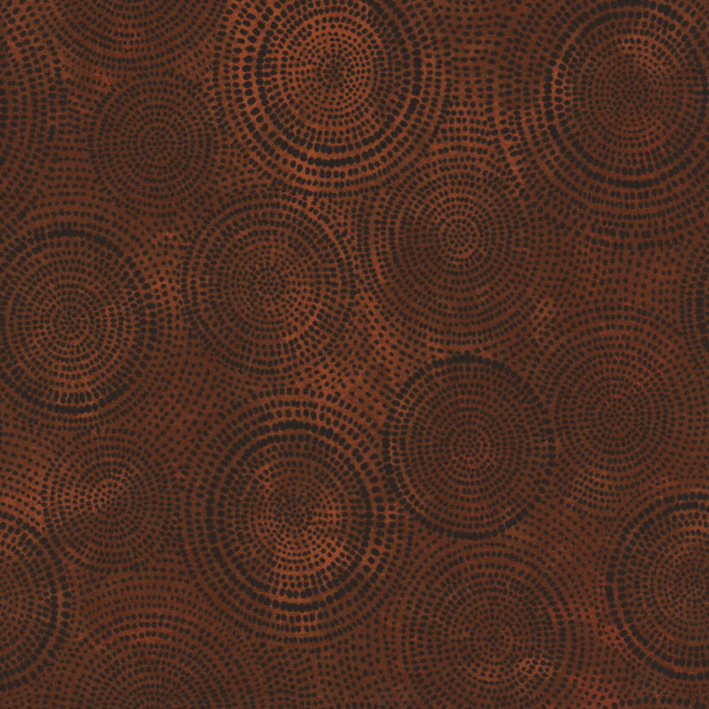 Photo of brown mottled fabric with darker tonal rings made up of tiny dashes