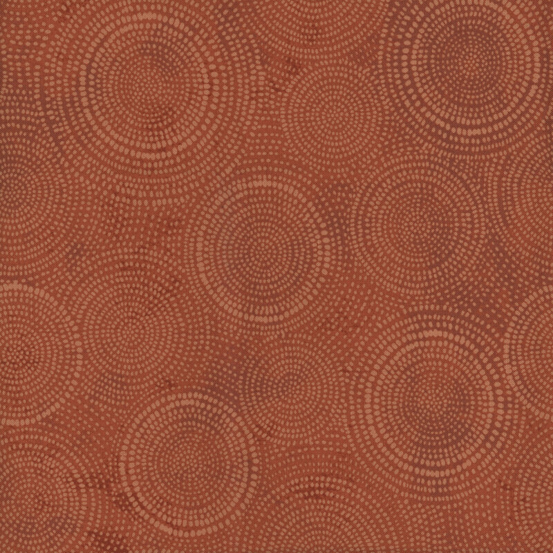 Photo of brown mottled fabric with lighter tonal rings made up of tiny dashes