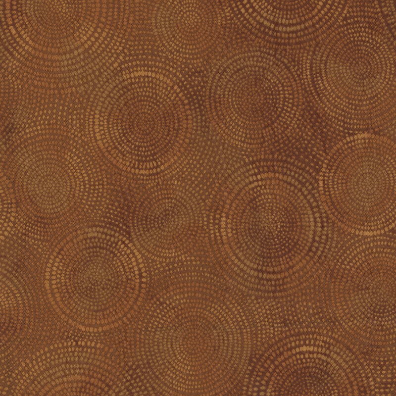 Photo of brown mottled fabric with lighter tonal rings made up of tiny dashes
