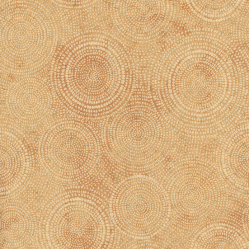 Photo of tan mottled fabric with lighter tonal rings made up of tiny dashes