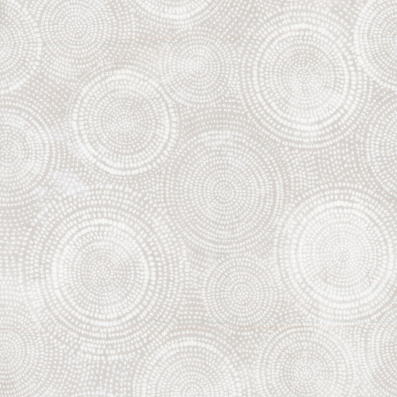 Photo of light gray mottled fabric with lighter tonal rings made up of tiny dashes
