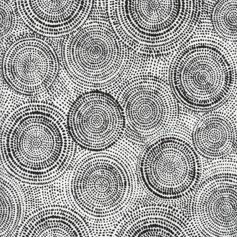 Photo of white fabric with black tonal rings made up of tiny dashes