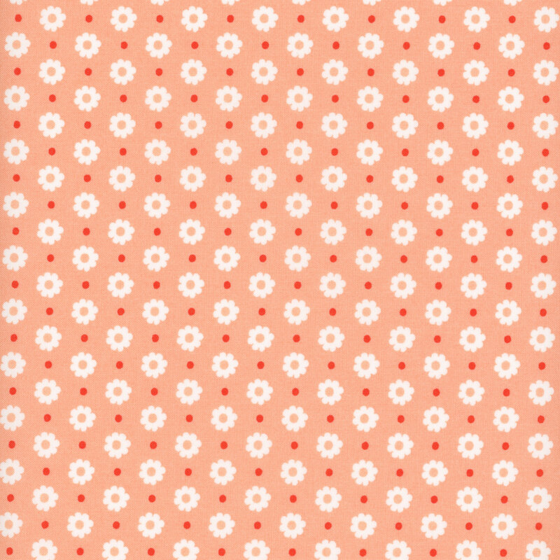 peach fabric featuring white flower heads and red dots