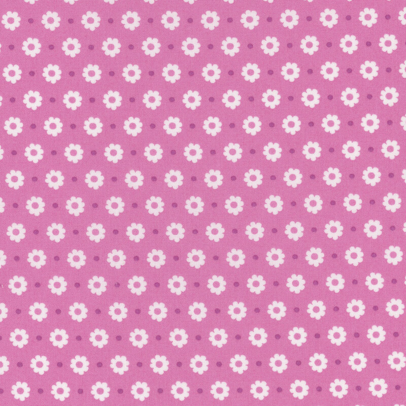 fuchsia fabric featuring white flower heads and purple dots