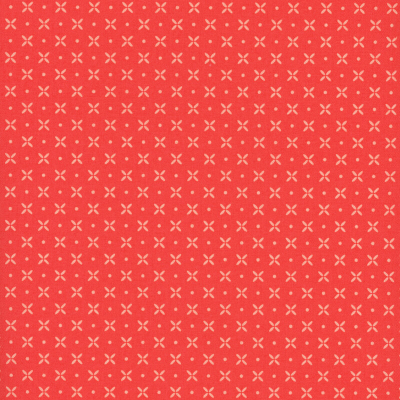 red fabric featuring peach pinwheel flowers and dots