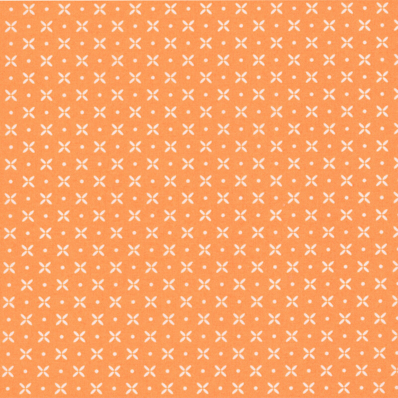 orange fabric featuring peach pinwheel flowers and dots