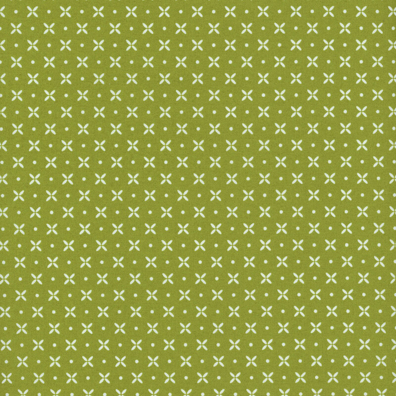 green fabric featuring white pinwheel flowers and dots