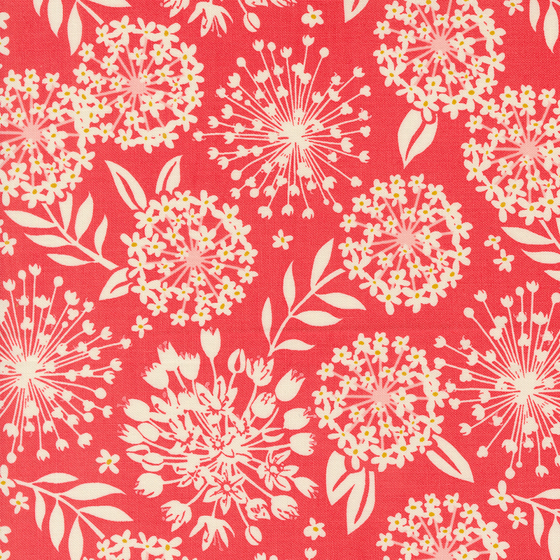 An image of a red colored fabric with cream colored silhouettes of flowers and leaves.