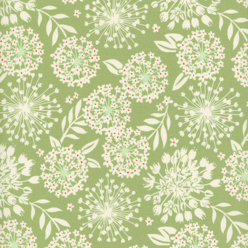 A green colored fabric with cream colored silhouettes of flowers and leaves and touches of red.