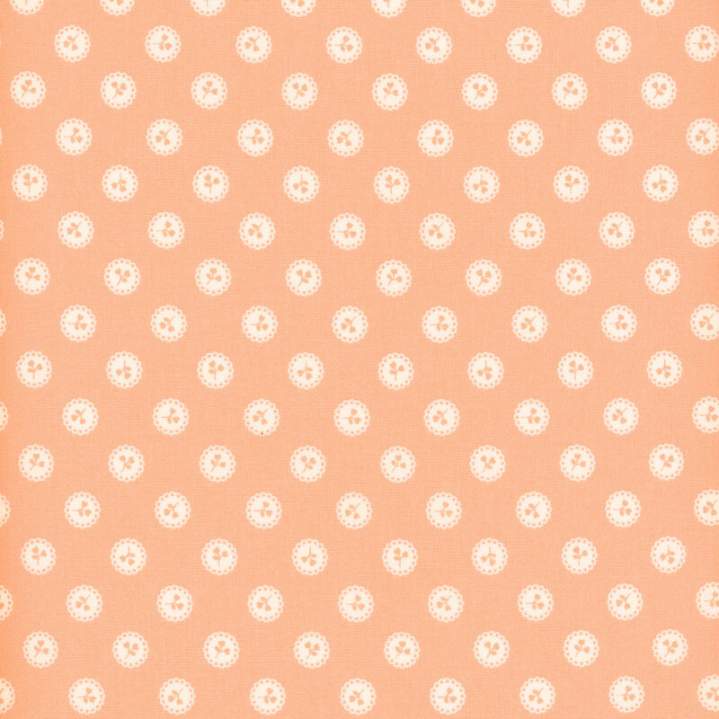 Pink fabric with a pattern of pink floral sprigs in white buttons.