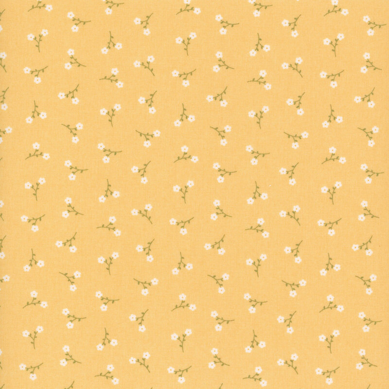 Yellow fabric with a pattern of tossed white floral sprigs.
