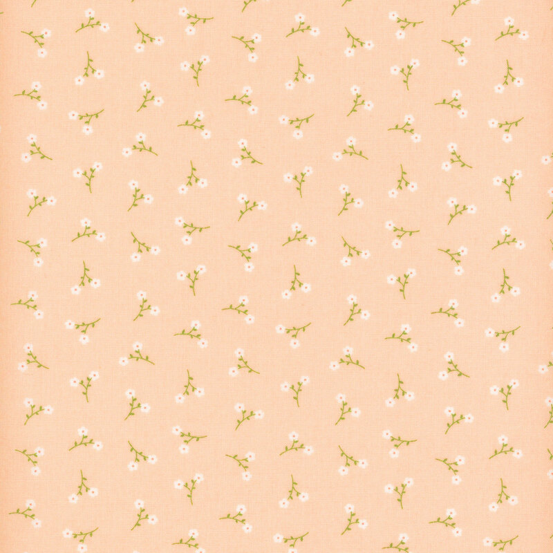 Pink fabric with a pattern of tossed white floral sprigs.