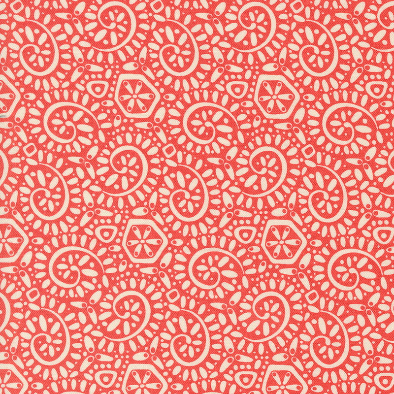 Red salmon fabric with a packed pattern of cream-colored ammonite swirls and dots.
