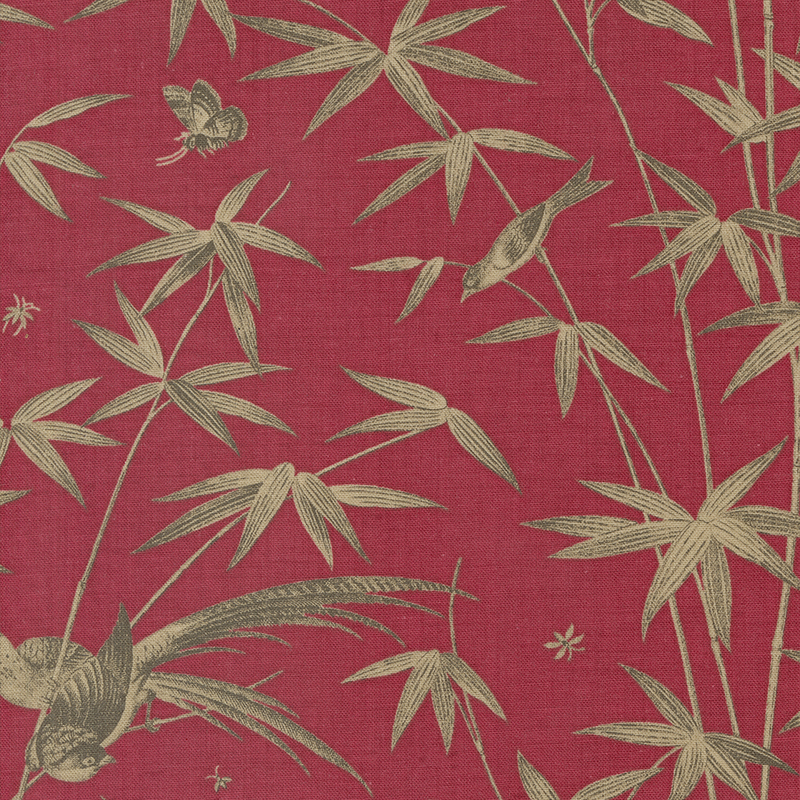 Red fabric featuring brown colored birds and bamboo shoots