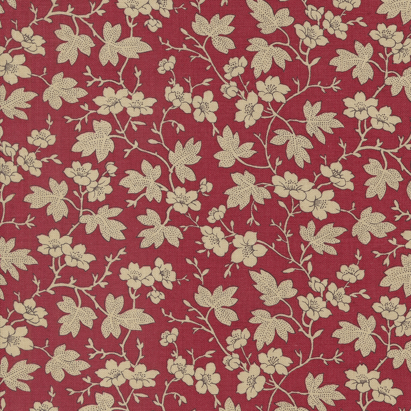 Red fabric featuring cream leaves and flowers