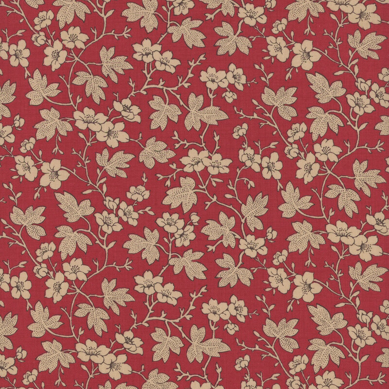 Red fabric featuring cream leaves and flowers