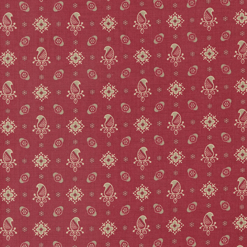 Red fabric featuring a pattern of paisleys and florals