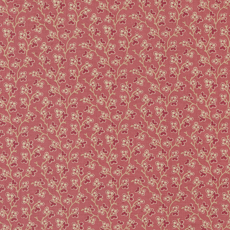 pink fabric featuring a dark pink and cream floral design