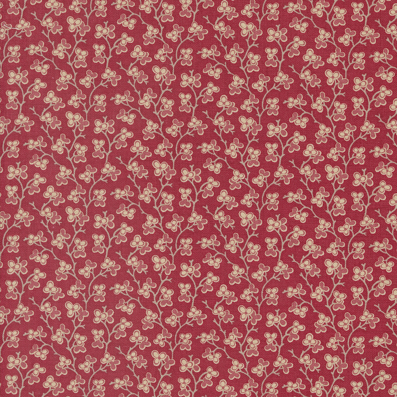 red fabric featuring a dark pink and cream floral design