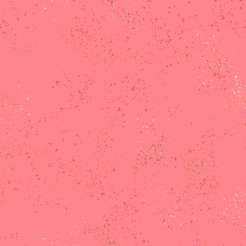 Bright pink fabric featuring varying shades of pink and gold metallic speckles throughout