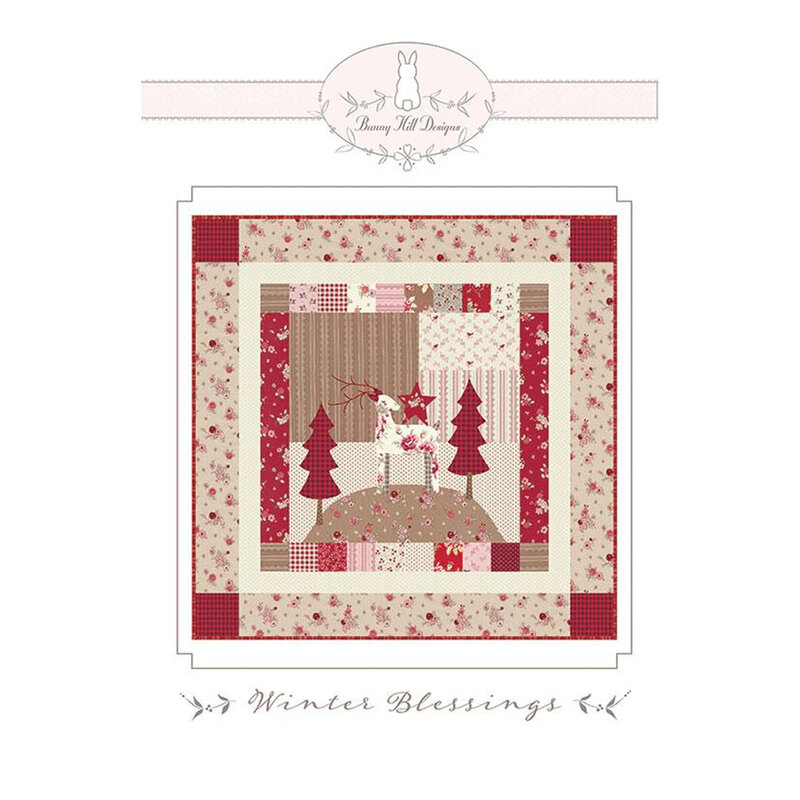 Front of the pattern, featuring an image of the finished quilt in red, pink, and cream featuring trees and a deer