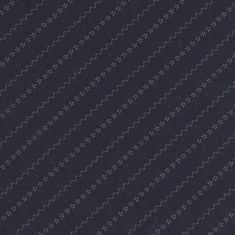 Deep navy blue fabric with alternating diagonal stripes of stars and zig-zag patterns