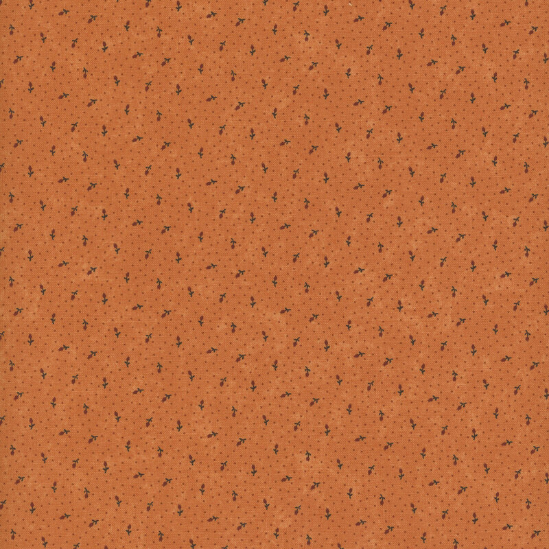 Rusty brown fabric with ditsy florals and subtle pin dots against a lightly mottled background