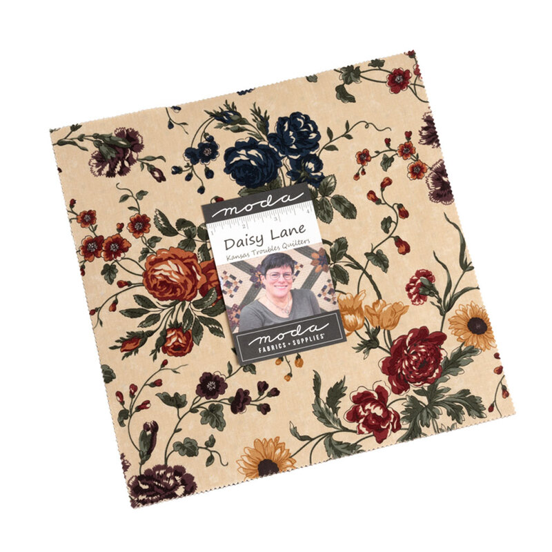 A square bundle of fabric showing a tan fabric with colorful florals and a Daisy Lane tag on top showing a photo of the designer