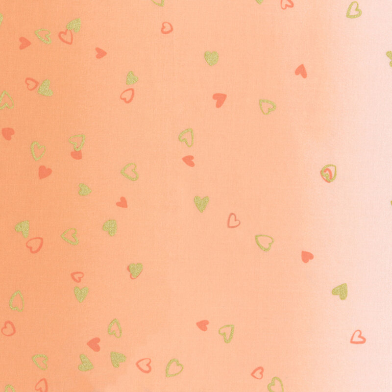 light peach fabric featuring an ombre design with small metallic and orange hearts