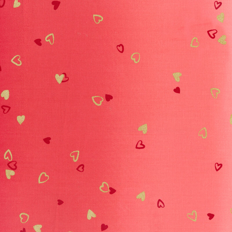 Red fabric featuring an ombre design with small metallic and dark red hearts